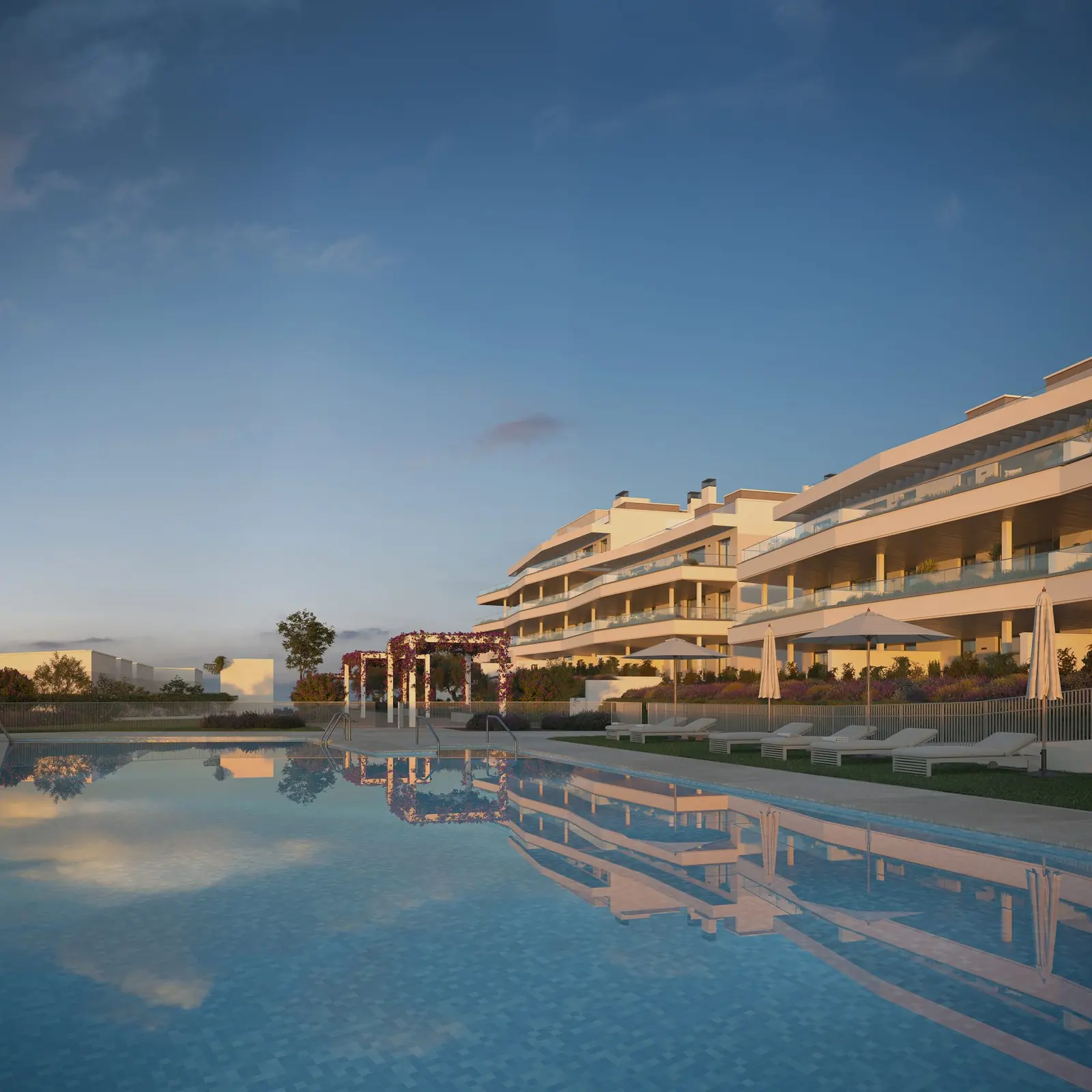 Infografía 3D de piscina comunitaria y fachada al anochecer de Vanian Park, promoción residencial en Estepona, Málaga (HCP Arquitectos)